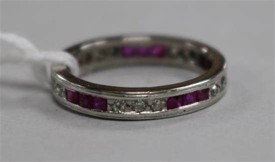 A white metal, ruby and diamond set full eternity ring, size L.